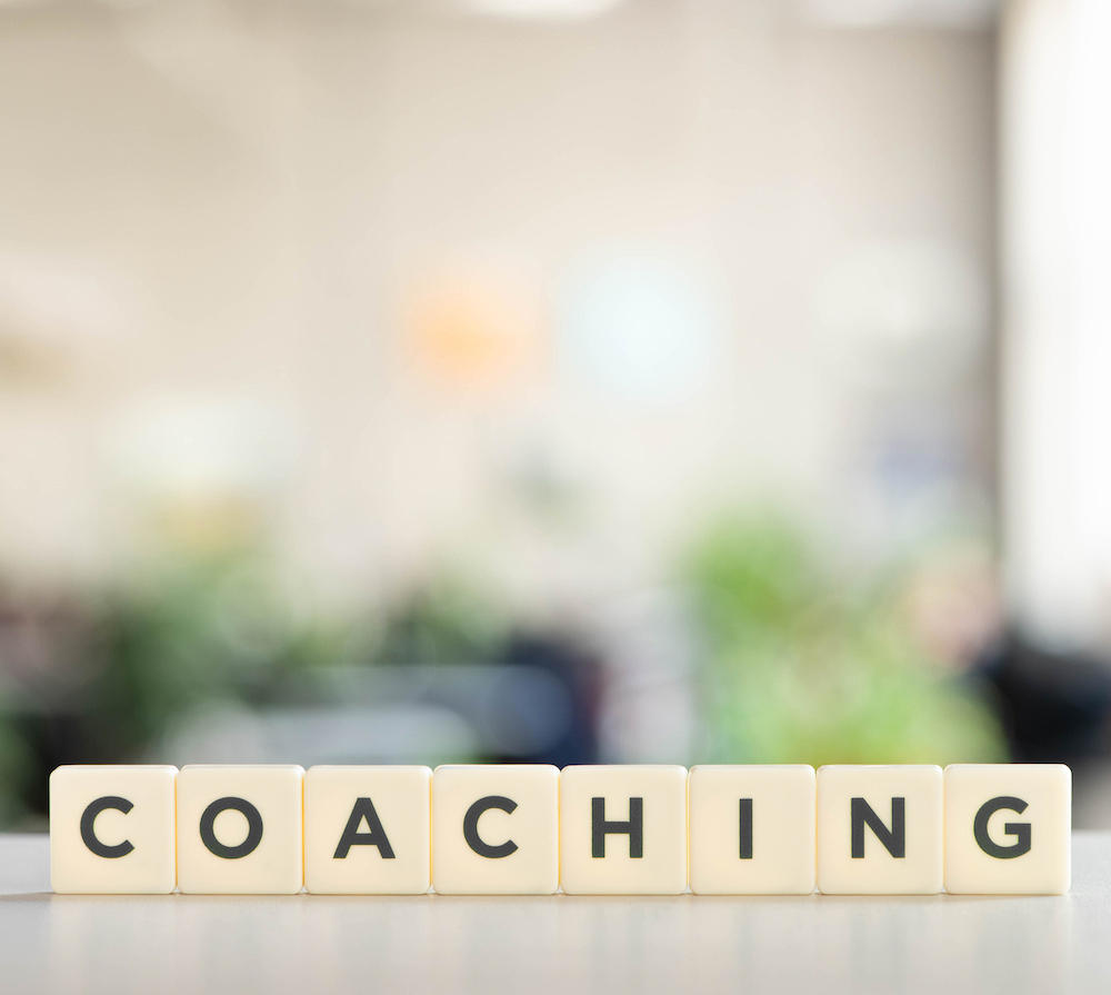 white cubes with coaching inscription on white desk